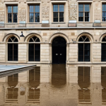 Flood Mitigation**

Prompt: Historic stone building with flood barriers in place, reflecting pools of water after a rain, demonstrating flood resilience.

**